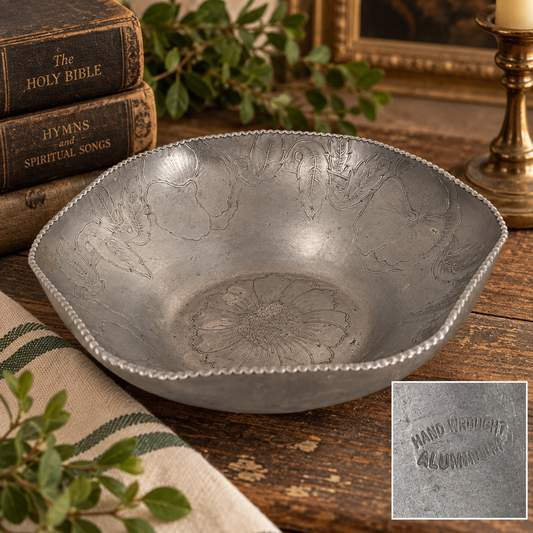 Styled vintage hand wrought aluminum floral bowl with old books, greenery and brass accents